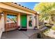 Welcoming front porch with a green door, decorative plants, and a charming bench at 5373 W Dublin Ct, Chandler, AZ 85226