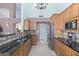 Bright kitchen with stainless steel appliances, tile backsplash, granite countertop, and wood cabinets at 5373 W Dublin Ct, Chandler, AZ 85226