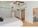 Bedroom showing barn door, hardwood flooring, natural light, ceiling fan, and ensuite bathroom at 5373 W Dublin Ct, Chandler, AZ 85226