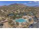 Community pool, tennis courts, and surrounding landscape at 6788 E Nightingale Star Cir, Scottsdale, AZ 85266