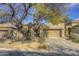 Desert landscape surrounds this single-story home with a two-car garage at 6788 E Nightingale Star Cir, Scottsdale, AZ 85266