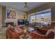 Living room with fireplace, mountain views, and southwestern art at 6788 E Nightingale Star Cir, Scottsdale, AZ 85266