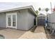 Exterior angle of house showing double french doors, back yard with storage building at 7018 E Wilshire Dr, Scottsdale, AZ 85257