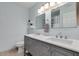 Well-lit bathroom with a double vanity, modern faucets, mirrors and stylish decor at 7018 E Wilshire Dr, Scottsdale, AZ 85257