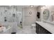 Bathroom features a glass shower, soaking tub, double sinks, and modern fixtures at 7018 E Wilshire Dr, Scottsdale, AZ 85257