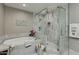 Luxury bathroom with separate shower, soaking tub, and modern finishes at 7018 E Wilshire Dr, Scottsdale, AZ 85257