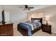 Comfortable bedroom featuring a plush bed, dark furniture, carpet flooring and a window with blinds at 7018 E Wilshire Dr, Scottsdale, AZ 85257