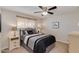 Cozy bedroom with carpet, ceiling fan, window, and coordinated decor for a relaxing ambiance at 7018 E Wilshire Dr, Scottsdale, AZ 85257