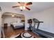 Bedroom showcasing a ceiling fan, hardwood floors and a large bed in a well-lit space at 7018 E Wilshire Dr, Scottsdale, AZ 85257