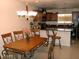 Open dining room with rustic wooden table, decorative chairs and chandelier lighting at 7018 E Wilshire Dr, Scottsdale, AZ 85257