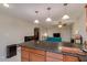 Kitchen island overlooking the living room with granite countertops and pendant lighting at 7018 E Wilshire Dr, Scottsdale, AZ 85257