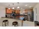 Modern kitchen featuring granite countertops, stainless steel appliances, and a breakfast bar with seating at 7018 E Wilshire Dr, Scottsdale, AZ 85257