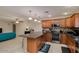 Well-equipped kitchen with stainless steel appliances, dark countertops and wooden cabinetry at 7018 E Wilshire Dr, Scottsdale, AZ 85257