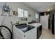 Well-lit laundry room featuring modern washer and dryer, storage, and convenient ironing station at 7018 E Wilshire Dr, Scottsdale, AZ 85257