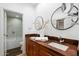 Bathroom with double vanity and walk-in shower at 7710 E Gainey Ranch Rd # 152, Scottsdale, AZ 85258