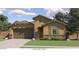 One-story home with brown garage doors and stone accents at 8030 E Palm Ln, Mesa, AZ 85212