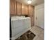 Spacious laundry room with washer, dryer, wooden cabinets, and tile flooring at 8260 E Keats Ave # 500, Mesa, AZ 85209