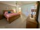 Comfortable main bedroom includes a ceiling fan, natural light, and simple decor at 8260 E Keats Ave # 500, Mesa, AZ 85209