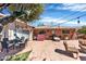 Backyard patio with brick flooring, furniture, and a red brick exterior at 8407 E Rancho Vista Dr, Scottsdale, AZ 85251