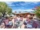 Brick backyard patio, surrounded by chairs, a small table, and beautiful flowers at 8407 E Rancho Vista Dr, Scottsdale, AZ 85251