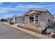 Attractive manufactured home with covered patio and landscaping at 8700 E University Dr # 2216, Mesa, AZ 85207