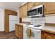 Bright kitchen with white appliances, ample counter space, and wood cabinets at 8700 E University Dr # 2216, Mesa, AZ 85207