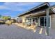 Charming covered back patio with comfortable seating and a view of the landscaped yard at 924 S Evergreen St, Chandler, AZ 85225