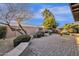 Spacious backyard featuring lush greenery, a covered patio, and beautiful hardscape at 924 S Evergreen St, Chandler, AZ 85225