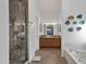 Bright bathroom featuring dual sinks, granite countertops, a tiled shower, and a separate soaking tub at 924 S Evergreen St, Chandler, AZ 85225