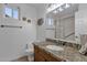 Well-lit bathroom featuring granite countertops, a single sink, and a walk-in shower at 924 S Evergreen St, Chandler, AZ 85225