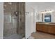 Bright bathroom with a tiled walk-in shower, dual sinks, and granite countertops at 924 S Evergreen St, Chandler, AZ 85225