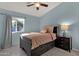 Well-lit bedroom with a gray platform bed, side table, and a window for natural light at 924 S Evergreen St, Chandler, AZ 85225