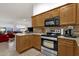 Well-equipped kitchen with modern appliances, wood cabinets, and granite countertops that overlook the living area at 924 S Evergreen St, Chandler, AZ 85225