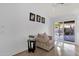 Cozy living room features a comfortable armchair, modern tile flooring, and sliding door access to the outdoor patio at 924 S Evergreen St, Chandler, AZ 85225