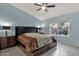 Main bedroom suite features a comfortable bed, ceiling fan, and a window with outdoor views at 924 S Evergreen St, Chandler, AZ 85225