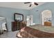 Bright main bedroom with dresser, ceiling fan, and en-suite bathroom, promoting comfort and convenience at 924 S Evergreen St, Chandler, AZ 85225