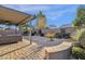 Covered patio with ample seating, a fan, and a view of the meticulously landscaped backyard at 924 S Evergreen St, Chandler, AZ 85225