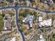 Aerial view of estate, desert landscaping, pool, solar panels, and circular driveway at 9290 E Thompson Peak Pkwy # 444, Scottsdale, AZ 85255