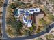 Aerial view of home with custom pool, desert landscaping, solar panels, and circular driveway at 9290 E Thompson Peak Pkwy # 444, Scottsdale, AZ 85255