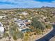 Aerial of desert home with pool, solar, landscaping, and mountain views at 9290 E Thompson Peak Pkwy # 444, Scottsdale, AZ 85255