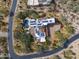 An aerial view of home with solar, pool, landscaping, and circular driveway at 9290 E Thompson Peak Pkwy # 444, Scottsdale, AZ 85255