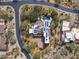 Beautiful aerial of home with solar, pool, desert landscaping, and spacious circular driveway at 9290 E Thompson Peak Pkwy # 444, Scottsdale, AZ 85255