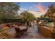 Outdoor patio featuring a stone table and seating near a built-in barbecue and fireplace at 9290 E Thompson Peak Pkwy # 444, Scottsdale, AZ 85255