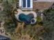 Aerial view of the pool and hot tub with beautiful pavers, solar panels on the roof, and desert landscaping at 9290 E Thompson Peak Pkwy # 444, Scottsdale, AZ 85255