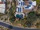 Aerial view of the pool and hot tub with beautiful pavers, solar panels on the roof, and desert landscaping at 9290 E Thompson Peak Pkwy # 444, Scottsdale, AZ 85255