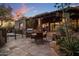 Outdoor dining area with a built-in grill and seating near desert landscaping in a private backyard at 9290 E Thompson Peak Pkwy # 444, Scottsdale, AZ 85255