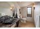 Unique bathroom with a stone sink, custom vanity, and warm lighting, creating a spa-like ambiance at 9290 E Thompson Peak Pkwy # 444, Scottsdale, AZ 85255