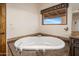 Relaxing soaking tub with tile surround and a view at 9290 E Thompson Peak Pkwy # 444, Scottsdale, AZ 85255