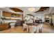 Dining area with stone floors, featuring a round table, plush chairs, a wine cooler, and wooden cabinets at 9290 E Thompson Peak Pkwy # 444, Scottsdale, AZ 85255