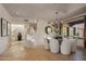 Elegant dining area featuring stone floors, chandelier, a large window overlooking the desert landscape and staircase at 9290 E Thompson Peak Pkwy # 444, Scottsdale, AZ 85255